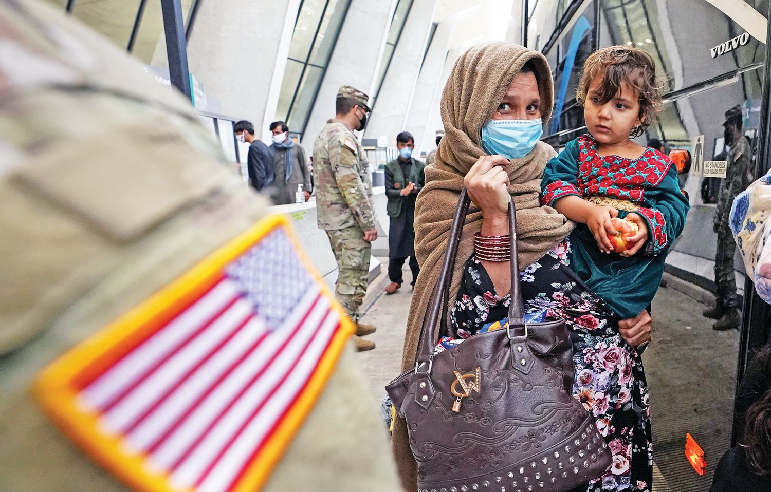 Upon their arrival, refugees from Afghanistan board a bus at Dulles International Airport in Dulles, Virginia., Sept. 1, 2021, taking them to a processing center.